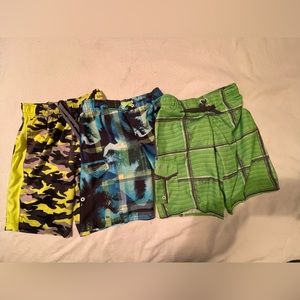 3 pairs boys swim trunks yellow camouflage, blue and green. See description